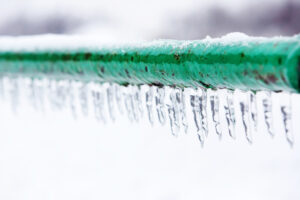 Frozen icy green pipe