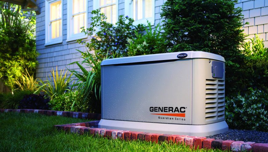 Generac generator next to a house and bushes.